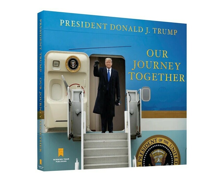 President Donald J. Trump raises a fist while standing at the door of Air Force One. The image is featured on the cover of the book titled "Our Journey Together," published by Winning Team Publishing. The book cover's background is blue with the presidential seal visible near the aircraft door.