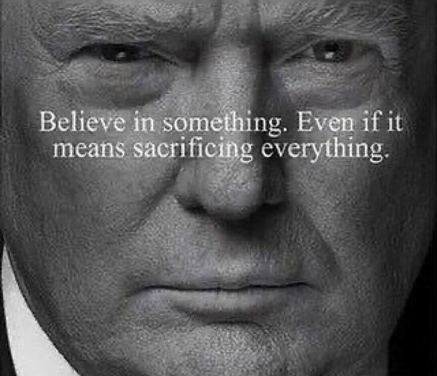 Close-up black-and-white photograph of a serious-looking man's face with the quote, "Believe in something. Even if it means sacrificing everything." written across his image.