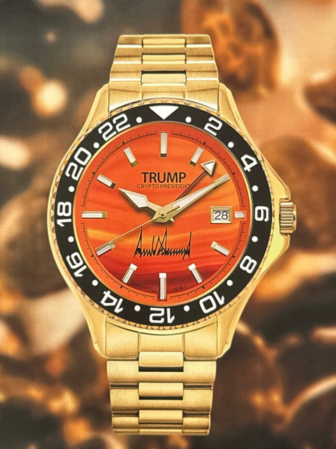 Gold wristwatch with an orange gradient dial, black bezel, and date feature. The dial displays the name "Trump" with "Crypto President" written beneath. The signature-like design is present at the center, with indices marking each hour, and a two-tone metal bracelet completes the watch's look.