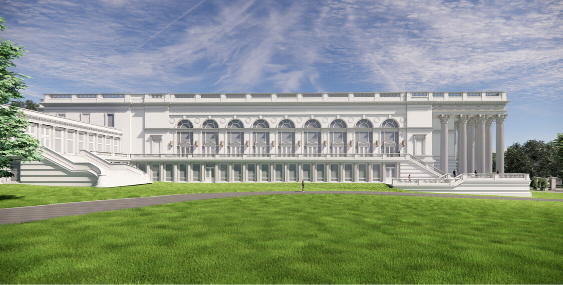 Neoclassical building with grand columns and arched windows, surrounded by a lush green lawn and a clear blue sky.