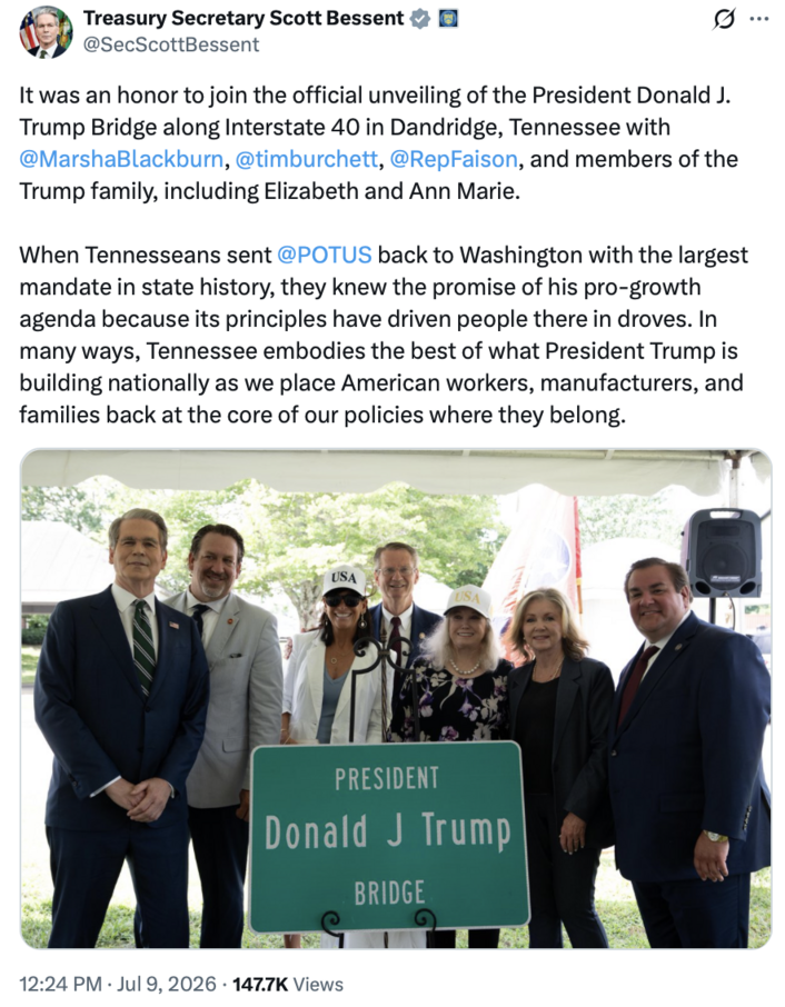 A group of people, including politicians and members of the Trump family, stand smiling in front of a sign that reads "President Donald J. Trump Bridge." They are gathered at the unveiling event along Interstate 40 in Dandridge, Tennessee. The tweet mentions celebration of pro-growth policies and the importance of American workers and families.